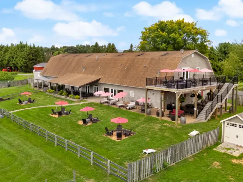 Aerial view of 8 Chains North Winery with its patio seating, upper deck, and surrounding lawn