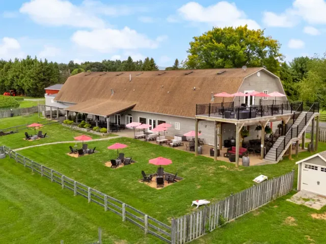 Aerial view of 8 Chains North Winery with its patio seating, upper deck, and surrounding lawn