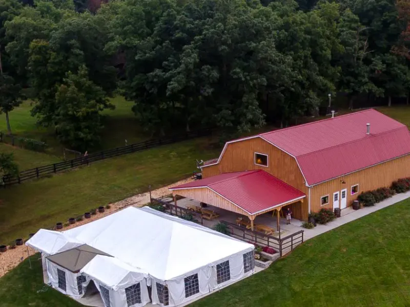 Aerial view of Barnhouse Brewery with its red-roofed barn building and tented lawn space