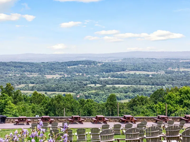 Terraced seating at Bear Chase Brewing Company overlooking a wide Bluemont valley view