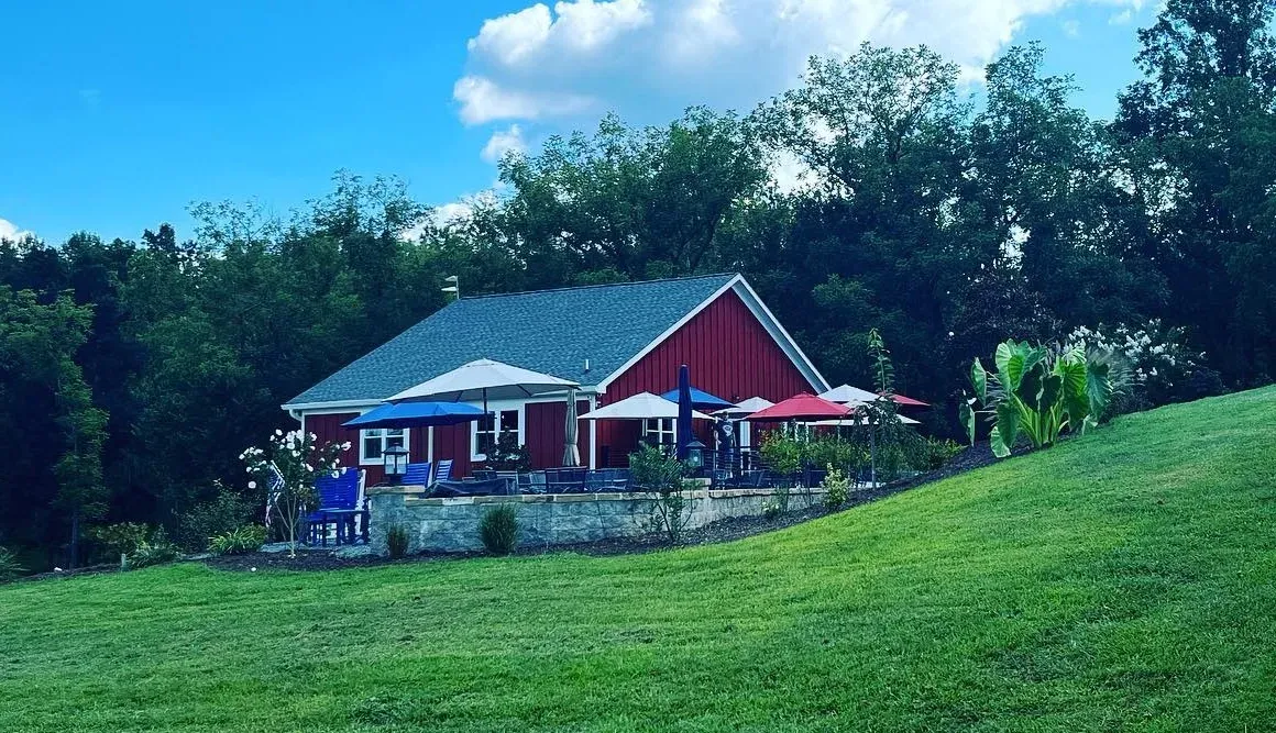 Endhardt Vineyards red tasting room on a green hillside