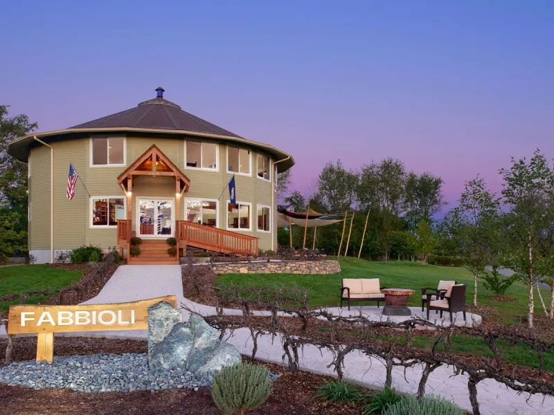 Fabbioli Cellars tasting room and sign at dusk