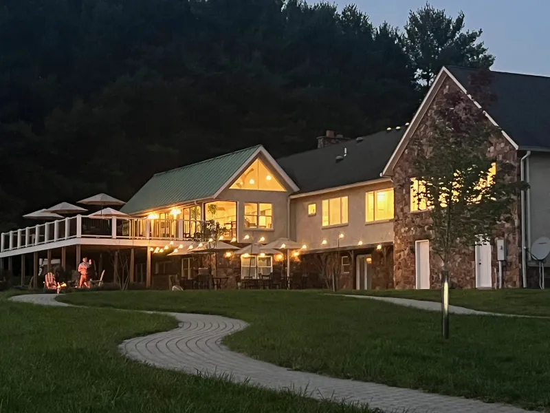 Good Spirit Farm Winery tasting room glowing at dusk