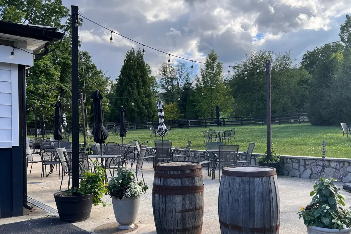 Old 690 Brewing Company patio with string lights and barrel tables