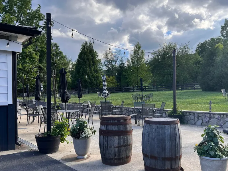 Old 690 Brewing Company patio with string lights and barrel tables