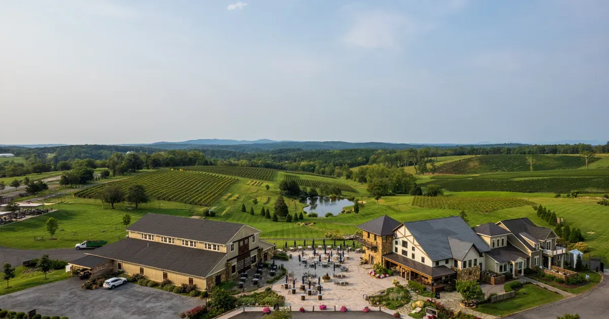 Aerial view of Stone Tower Winery with its courtyard, buildings, and surrounding vineyard hills