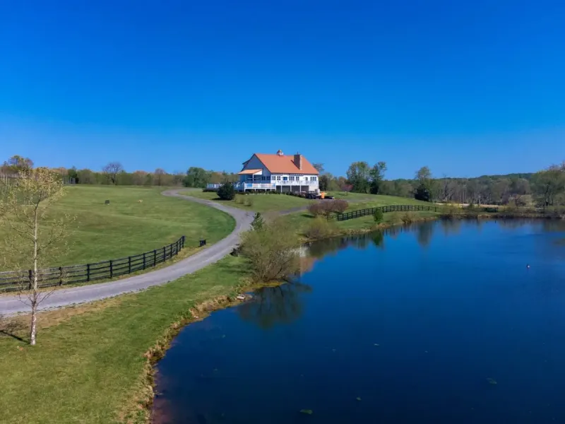 Droumavalla estate winery overlooking vineyard rows and a pond