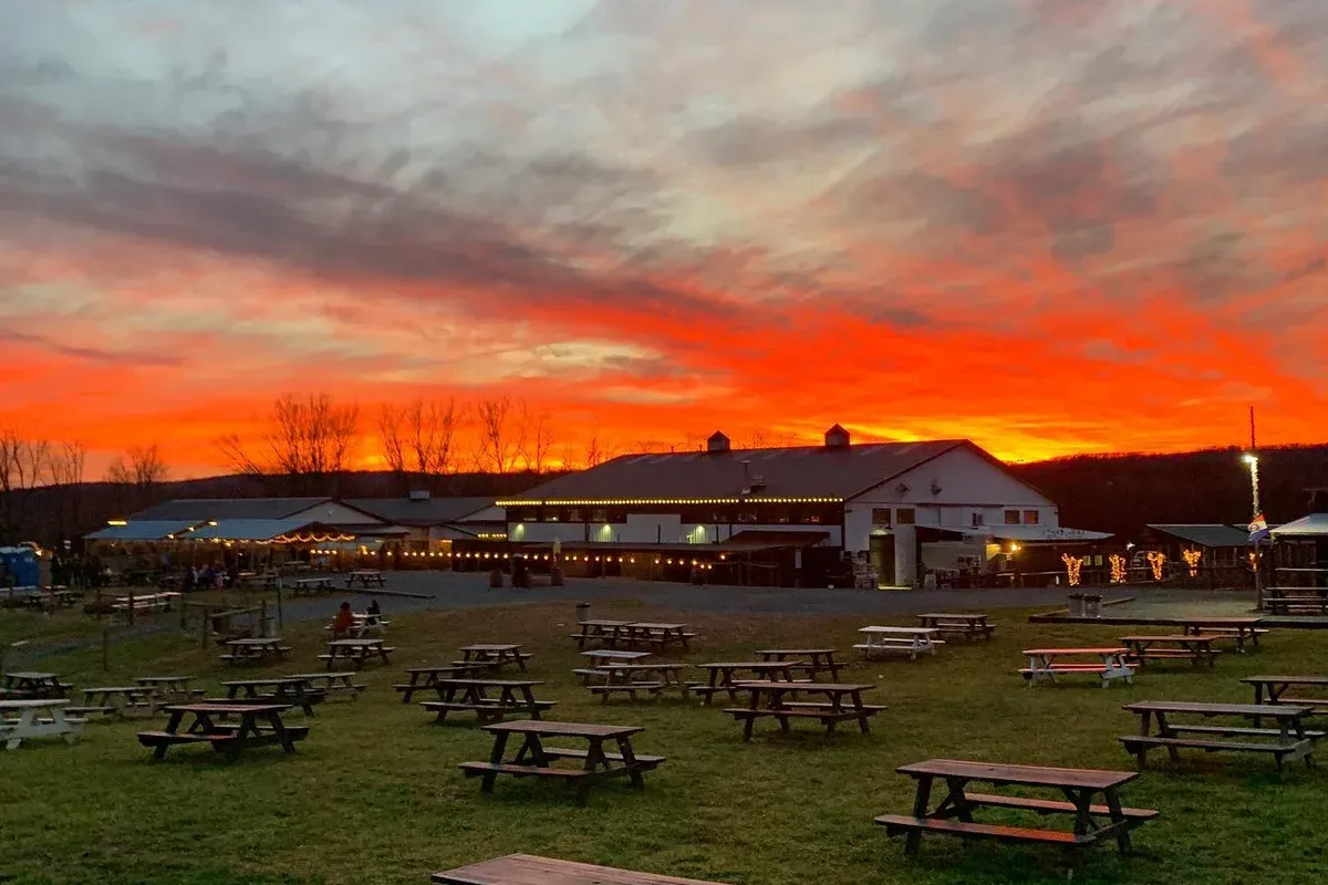 Vanish Farmwoods Brewery lawn and picnic tables at sunset