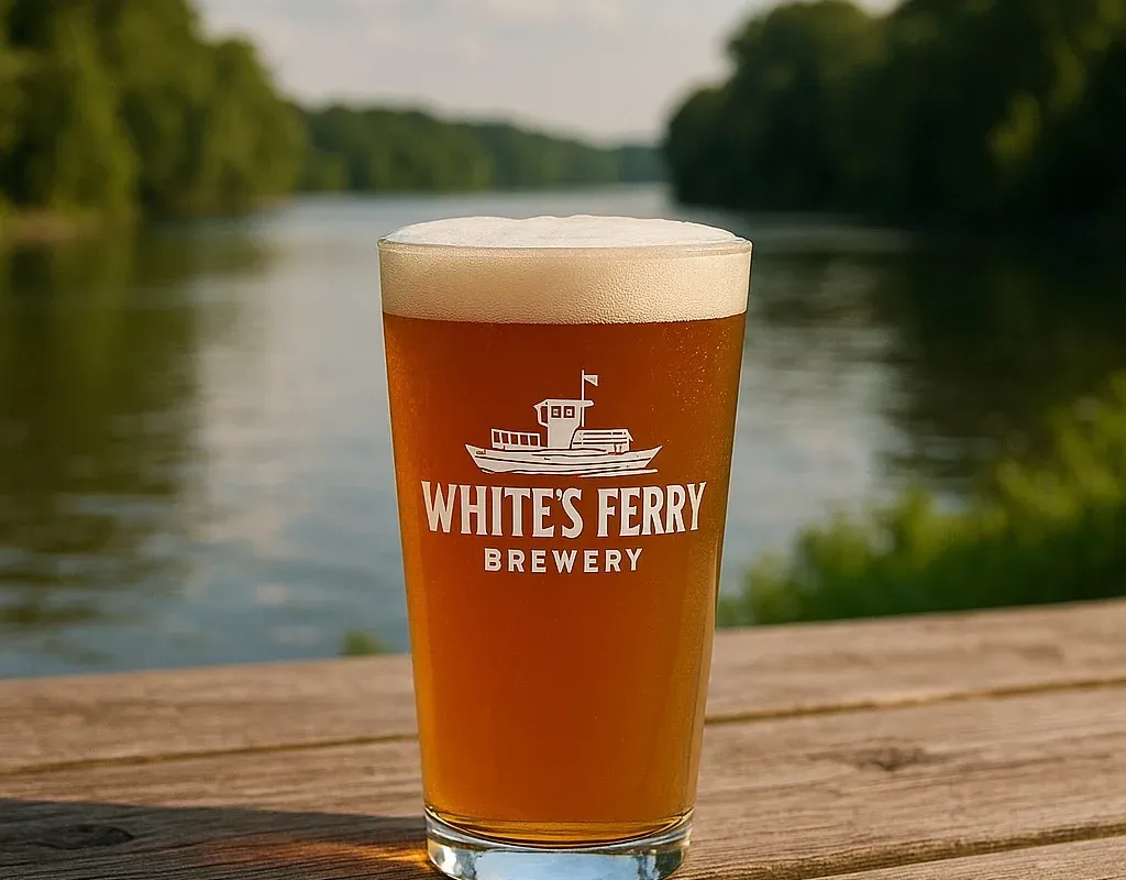White's Ferry Brewery beer glass on a table overlooking the Potomac River
